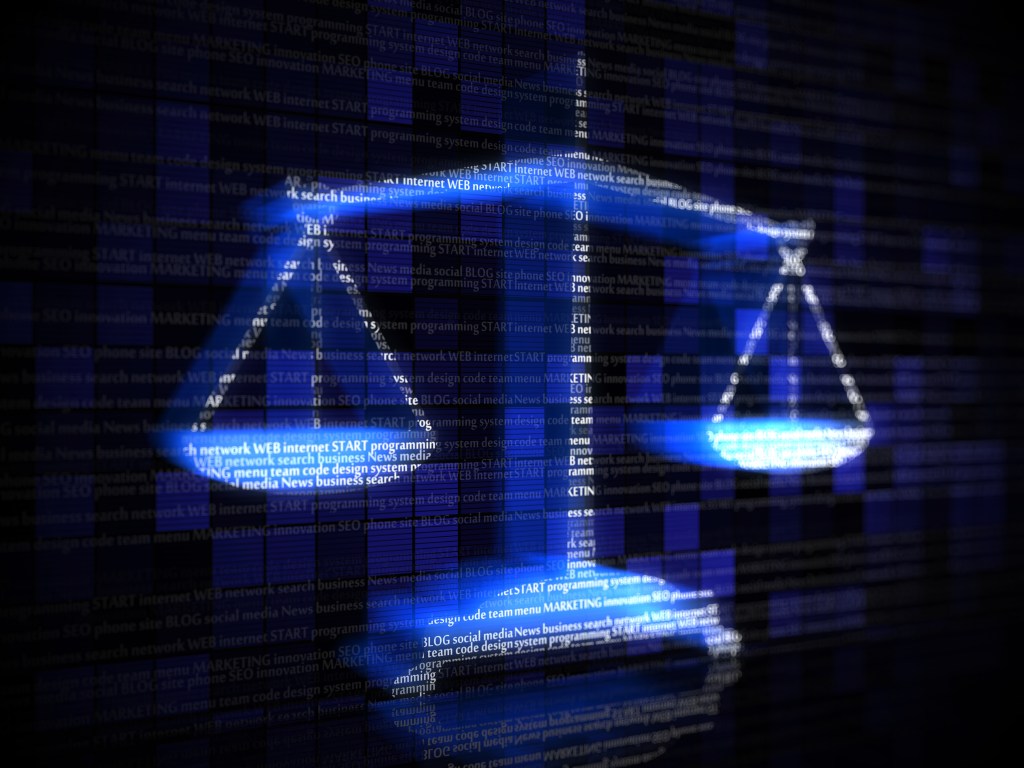 A 3-D illustration of scales lit up against a dark electronic background with computer terms in pale letters.