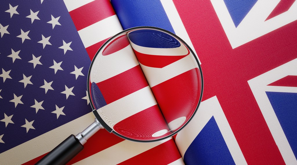 American and British flag pair under a magnifier.