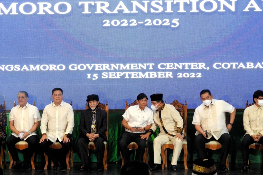 Philippine President Ferdinand Marcos Jr (C) speaks with Murad Ebrahim (3rd R), then-chief minister of Bangsamoro Autonomous Region of Muslim Mindanao (BARMM), as Nur Misuari (3rd L), leader of the Moro National Liberation Front (MNLF), looks on during the ceremonial opening of the Bangsamoro Transitional Authority (BTA) in Cotabato City, in the southern Philippines on September 15, 2022. (Photo by STR/AFP via Getty Images)