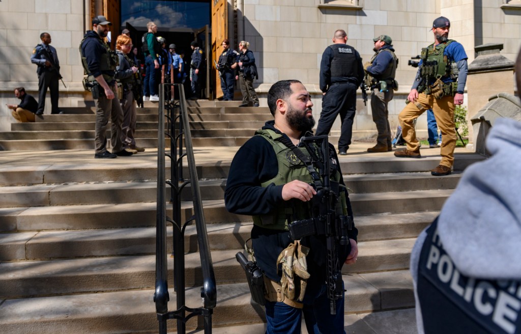Police maintain a presence outside a command center holding evacuated students following the lockdown of the school after a call of an active shooter on March 29, 2023 in Pittsburgh, Pennsylvania. Many schools, including Oakland Catholic and Pittsburgh Central Catholic, were targeted as part of what authorities are calling "computer-generated swatting calls." Many agencies, including state and municipal police, are conducting investigations. (Photo by Jeff Swensen/Getty Images)