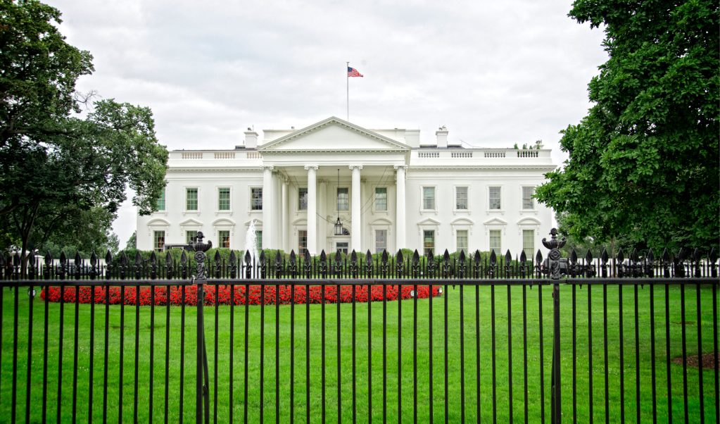 White House with red flowers in the foreground