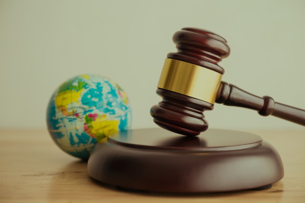 Gavel in front of a globe