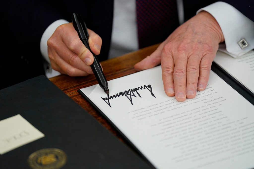 President Donald Trump signs an executive order