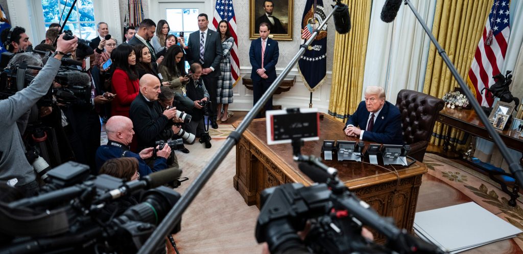 President Donald J Trump speaks with reporters and signs executive orders in the Oval Office