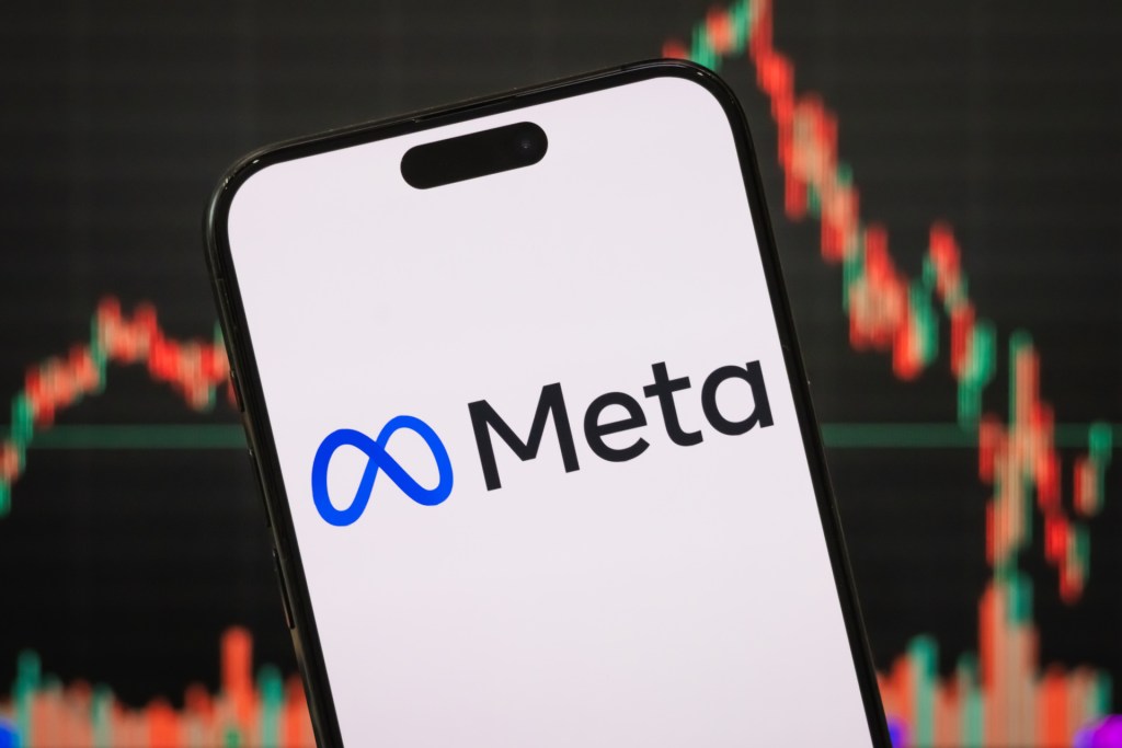 n this photo illustration, the logo of Meta Platforms, Inc. is displayed on a smartphone screen, with the company's latest stock market performance and candlestick chart visible in the background.(Photo illustration by Cheng Xin/Getty Images)