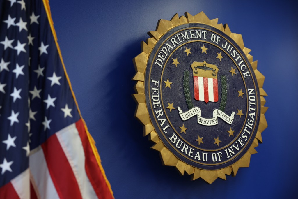 The logo of the Federal Bureau of Investigation (FBI) is seen at the Los Angeles Federal Building in May 2025. (Photo by PATRICK T. FALLON/AFP via Getty Images)