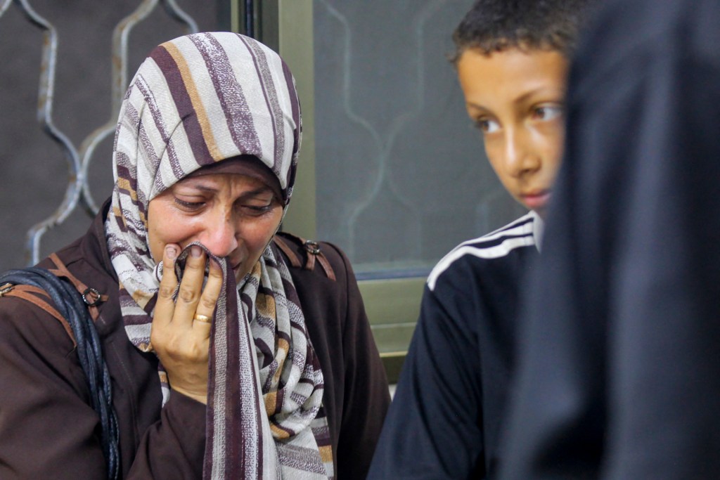 People mourn at the morgue of Al-Awda hospital, in Nuseirat camp in central Gaza on June 20, 2025, after several Palestinians were killed as they reportedly headed to a food distribution centre in the war-stricken Gaza Strip, amid the ongoing conflict between Israel and the Palestinian Hamas militant group. (Photo by AFP) (Photo by -/AFP via Getty Images)
