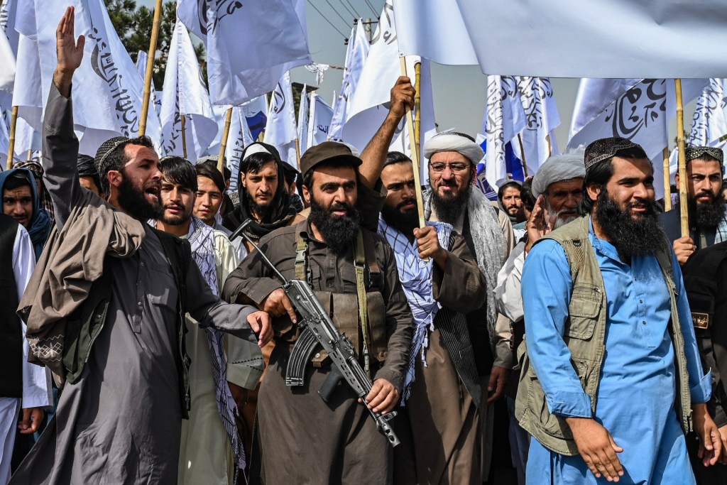 Taliban personnel shout slogans as they celebrate the fourth anniversary of their takeover of Afghanistan near the Kabul Polytechnic University in Kabul on August 15, 2025. (Photo by WAKIL KOHSAR/AFP via Getty Images)