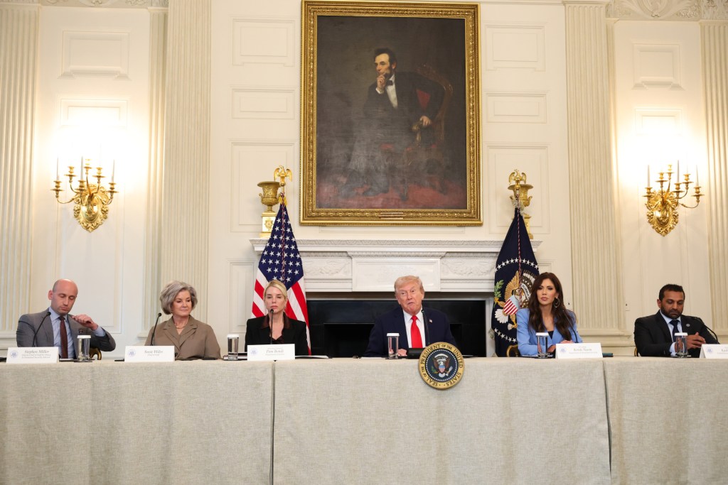 U.S. President Donald Trump (C) speaks as (L-R) White House Deputy Chief of Staff Stephen Miller, White House Chief of Staff Susie Wiles, U.S. Attorney General Pam Bondi, U.S. Secretary of Homeland Security Kristi Noem and Federal Bureau of Investigation Director Kash Patel listen during a roundtable discussion in the State Dining Room of the White House on October 08, 2025 in Washington, DC. Trump’s administration held the roundtable to discuss the anti-fascist Antifa movement after signing an executive order designating it as a “domestic terrorist organization”. (Photo by Anna Moneymaker/Getty Images)