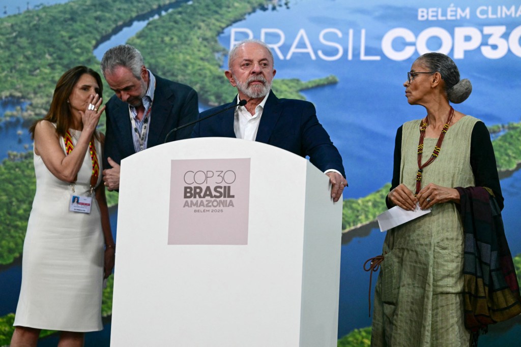 Brazil's President Luiz Inacio Lula da Silva (C) speaks alongside Environment Minister Marina Silva (R), COP30 President Andre Correa do Lago (2nd L), and COP30 CEO Ana Toni during a press conference