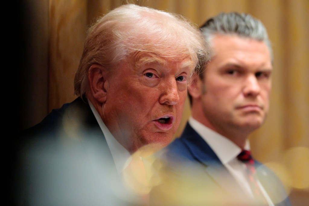 WASHINGTON, DC - DECEMBER 02: U.S. Secretary of Defense Pete Hegseth (R) looks on as U.S. President Donald Trump speaks during a meeting of his Cabinet in the Cabinet Room of the White House on December 02, 2025 in Washington, DC. (Photo by Chip Somodevilla/Getty Images)