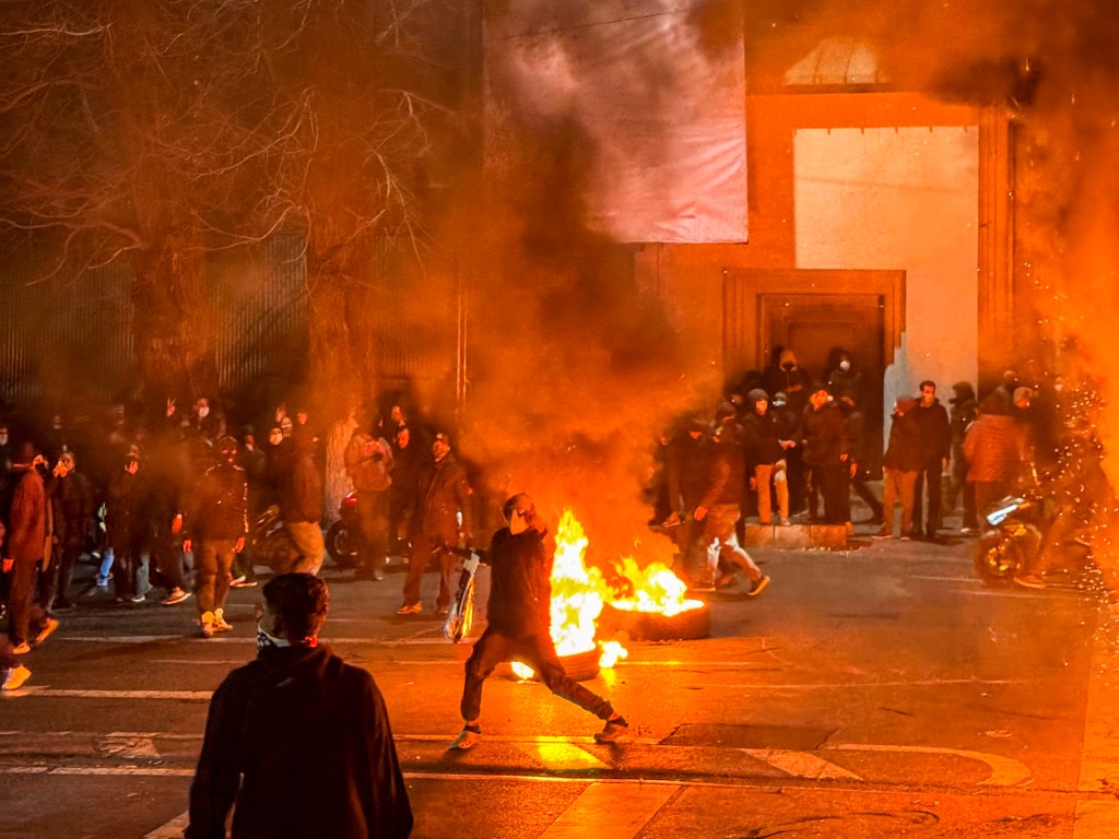 Iranians gather while blocking a street during a protest in Tehran, Iran on January 9, 2026. The nationwide protests started in Tehran's Grand Bazaar against the failing economic policies in late December, which spread to universities and other cities, and included economic slogans, to political and anti-government ones. (Photo by MAHSA / Middle East Images / AFP via Getty Images)