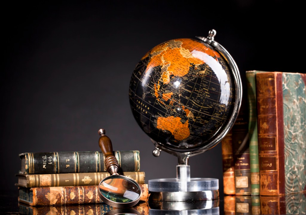 A globe in front of books
