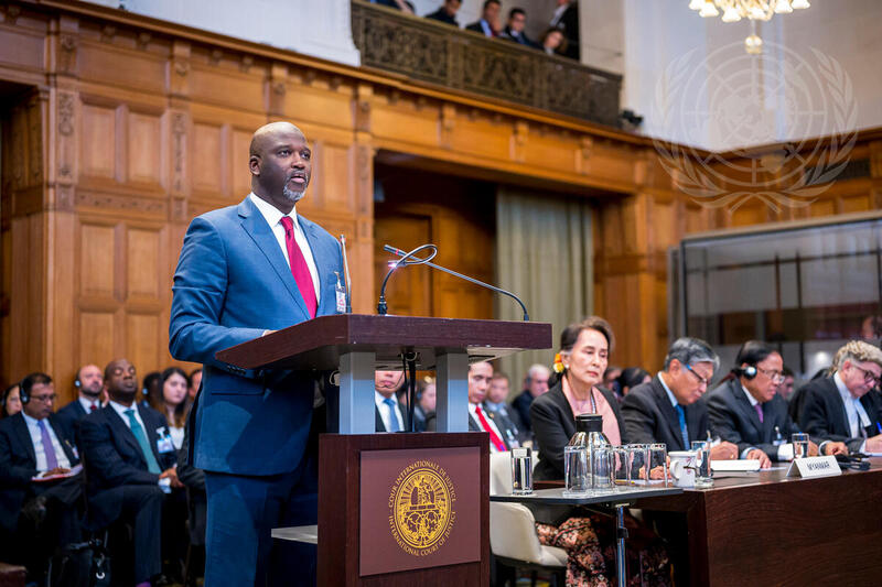 The Agent of The Gambia, Abubacarr Marie Tambadou, Minister of Justice and Attorney General of the Gambia, speaks on the first day of the December 2019 hearings before the International Court of Justice. Seated at the front is the Agent of Myanmar, Aung San Suu Kyi, Union Minister for Foreign Affairs of the Republic of the Union of Myanmar.