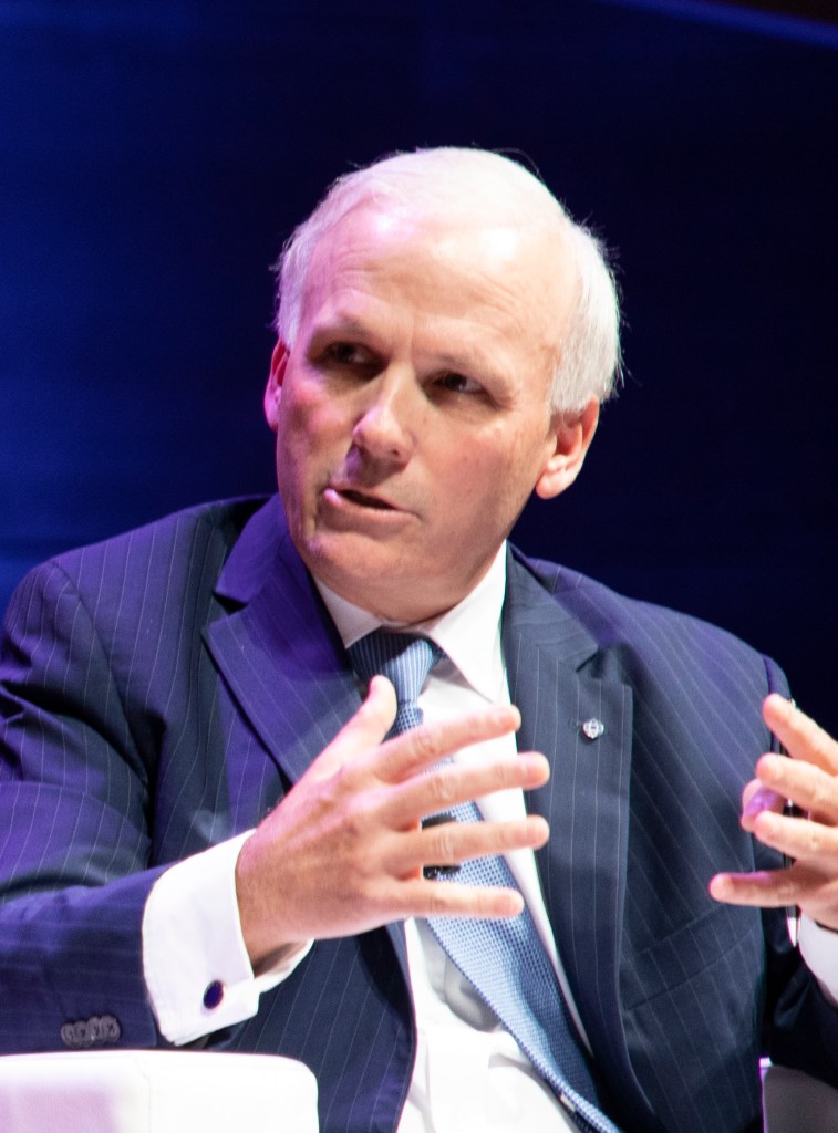 Mark Ellis seated, speaking.